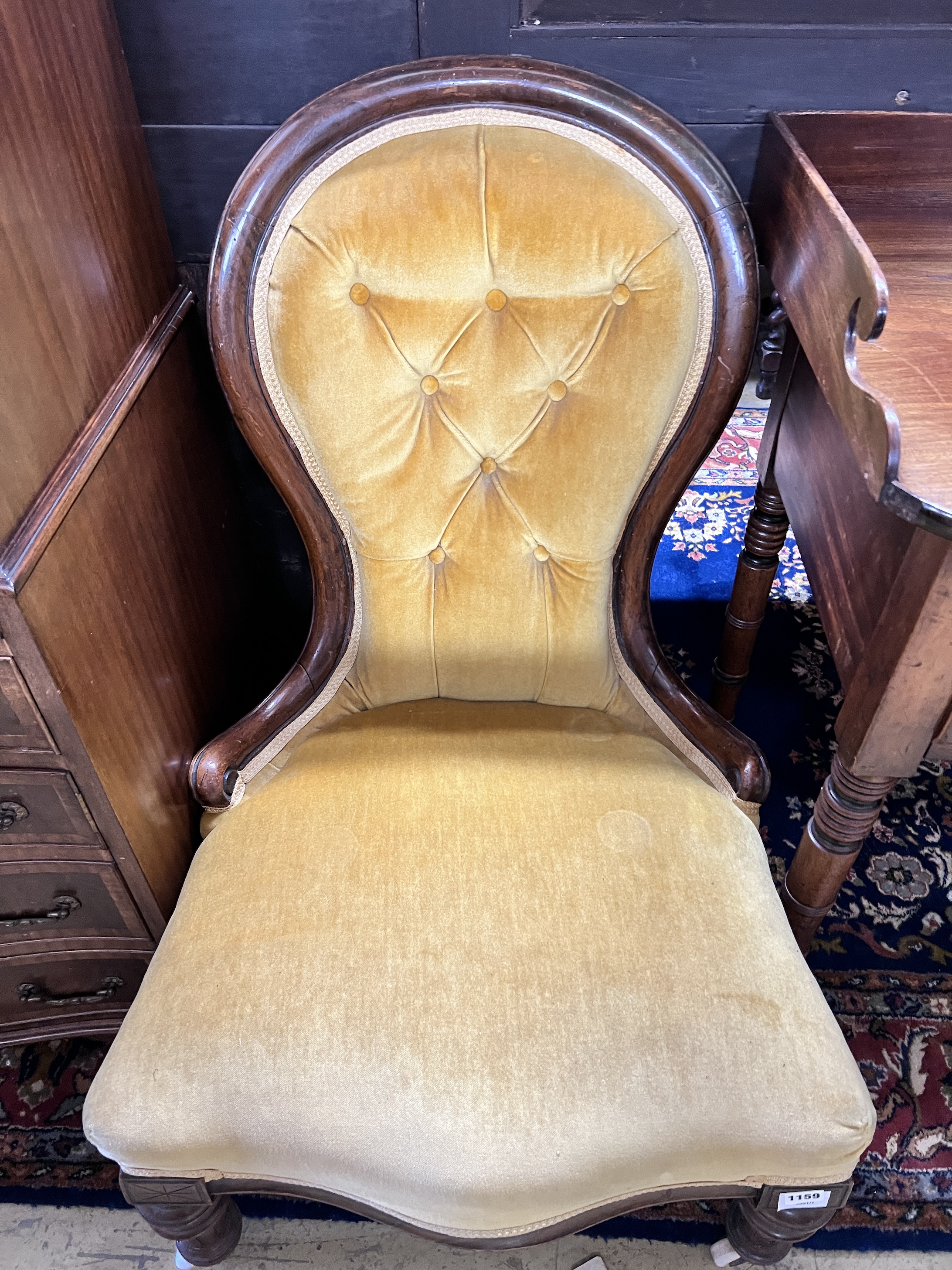 A Victorian mahogany spoonback nursing chair